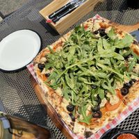 Pizza w handmade vegan cheese and stack of veggies at Stove On 스토브온 in Jeju