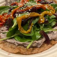 Galette bretonne topped with black beans and peanut sauce, peppers and caramelised onions at Col Cavolo - Vegan Bistrot in Rome