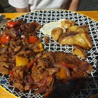Sweet and sour seitan with mustard and red peppers and side of potatoes €13.00 at Col Cavolo - Vegan Bistrot in Rome