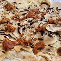 Vegan pizza with mushrooms and soy and a lot of vegan cheese at La Soffitta Renovatio in Rome