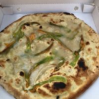 Pizza with vegan cheese and zucchini flowers. Delicious!  at La Soffitta Renovatio in Rome