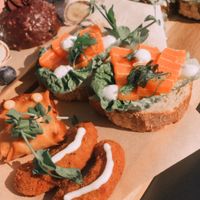 Avocado Fries, loempia’s, salmon toast, falafel wrap ánd mexican toast on this platter.  at Beyond Lunchcafé & Patisserie in Nuenen