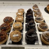 Various fine patisserie options, all labeled  at Land & Monkeys - Amsterdam in Paris