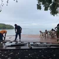 Building decking without edge protection whilst inviting kids to sit on completed areas  at El Pital in Ometepe