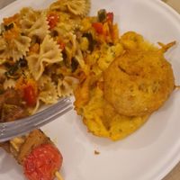 Pasta, fritters, and a spear with veg and faux meat at La Cucina Dei Colori in Catania