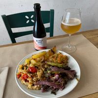 Roasted potatoes, pasta, smoked broccoli with wine sauce, and fritters (millet, chickpea). Mango kombucha. at La Cucina Dei Colori in Catania