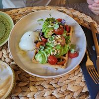 Waffles w avocado, tomato, pesto, pine nuts (ask to put the poached egg on the side for husband) at Noranta Tres in Escaldes-engordany