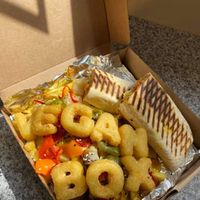 Vegan loaded fries box - goujon wrap with nuggets, cheese, fries, peppers, onions, curry sauce and alphabites! at The Picnic Basket in Prestwick