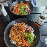 Crispy soy steak on rice with hoi sin sauce (9 Com Hoisin) below and tofu with spicy peanut sauce (Memory Nuss) above at Bodhicitta Vegan Bowl in Berlin