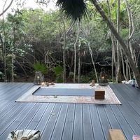 Yoga on the mangrove platform  at The House of AïA in Playa Del Carmen