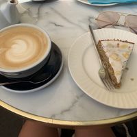 Vegan almande Cake with oat latte (the cake wasn’t labelled vegan but gluten free, after asking said was).  at HUG Cafe in Nice
