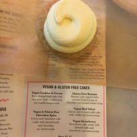 Lemon vegan cupcake, plus menu highlighting vegan items at Little Cupcake Bakeshop in New York City