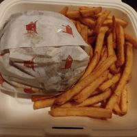 Burger and fries in takeaway box at The Tavern in Prague