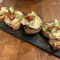 Daily smoked bruschetta appetizer  at Unique (V) Pizzeria SUKHASANA in Osaka