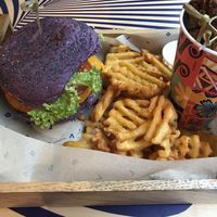 Tangy burger, “wedges” and “chicken bites” tasting like bread. Fun colored but poor taste.  at Flower Burger in Amsterdam