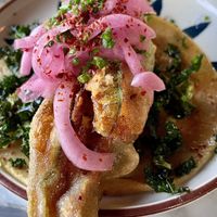 SQUASH BLOSSOM
lightly fried squash blossom stuffed with vegan chihuahua cheese, crispy kale, pickled onion, aleppo, sumac, chives  at Tu Madre in West Hollywood