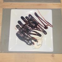 Vegan chocolate brownie with vegan vanilla ice cream and chocolate sauce.  at The White Swan Inn in Lowick