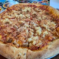 Sourdough crust, spicy red sauce, vegan mozzarella, pineapple, and vegan sausage  at La Calavera in Atlanta