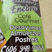 Sign posted outside at street level at El Enebro in Pereira