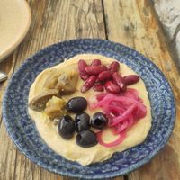 Hummus with black olives, red beans, caramelised onions and pickled eggplants. at Salt & Pepper in Medulin