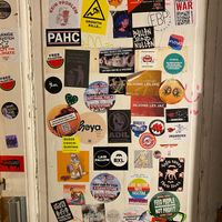 Political and funny stickers in the bathroom  at Kitsune Burgers in Brussels