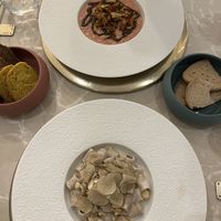 Rissoto (very complex flavors), Cashew & Truffle (creamy), provided bread on left and provides gluten free bread on the right (served warm)    at Linfa in Milan