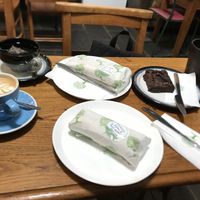 Our full order. Flat white with oat milk, breakfast tea with oat milk, two vegan wraps and an Oreo brownie   at Wyndenwell in Bamburgh