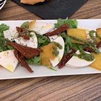 Fried polenta with sun dried tomatoes, rocket and vegan mozzarella  at PintXÓ in Fuerteventura