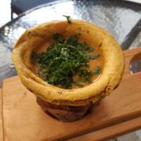 Vegan lentil soup in turmeric cup. at Soup Culture in Bratislava