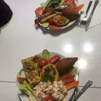 The bottom plate is completely vegan. The top one has the rolls that have cheese and the fish, which makes it non vegan.   at Paşa Hamam Cafe in Istanbul