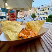 Tapita y la vista de la plaza. Karma Cola fair trade at Cala Vegana in Menorca