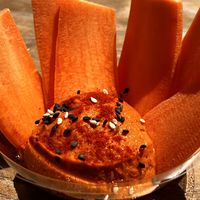 House offering: mise en bouche Carrots with orange hummus(?)  at Cala Vegana in Menorca