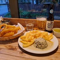 Vegan Haggis and chips with peppercorn sauce, onion rings, mushy peas, and thistly cross cider at The Real Food Cafe in Tyndrum