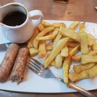 Vegan sausages and chips with gravy. at Barnacles in Llandudno