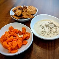 Nibbles while you wait, carrots with cumin, deliciously charred pita chips, and tahini at TLV in Marietta
