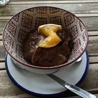 A “nata” dessert that has cacao and oatmeal and porto wine and topped with oranges. It is not a sweet dessert. Very nice texture.  at La Hormiga in Pontevedra
