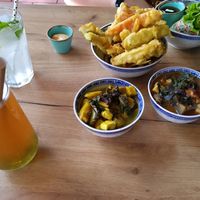 Clock-wise: deep-fried vegetables, spring rolls, tofu and eggplant, tofu and plantan, bubble tea, lemonade at La Vegana in Warsaw