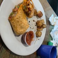 Breakfast burrito with tempeh sub for egg & cheese omitted…already ate half wrap & potatoes!  Good stuff!  at Cafe Eleven in St Augustine