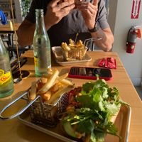 Banh mi sandwich with fries (he’s eating the Ruben sandwich) both delicious  at Plantology - Cloud Kitchen - Maybe closed in San Antonio