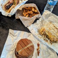 Chicken sandwich, Italian sausage sandwich, street corn, and friend fries at Plant Based Heat in Memphis