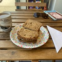 Seed risole sandwich and coffee with oat milk at Sebastien's Foods  in Paignton