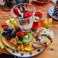 Small, sweet breakfast - yogurt, muesli, chocolate-banana croissant, different fruits, walnuts, jam at BABA Handmade Cafe in Leipzig