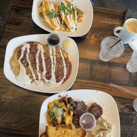 Breakfast quesadilla, strawberry cheesecake pancakes, and the breakfast platter with grits!   at Mo' Brunch + Brews in Houston
