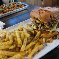 Black & Bluesy Burger with Viet-Nacho in the background   at Mo' Brunch + Brews in Houston