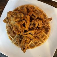 Waffles topped with Chikn Fried Shrooms tossed in our Hot Honey (Spiced Agave) syrup.  at Mo' Brunch + Brews in Houston