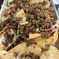Loaded nachos with a mix of imposible meat & smoked shrooms. 7/10 for me. They can use some work. The smoked shrooms gives it more flavor.   at Mo' Brunch + Brews in Houston