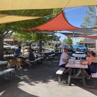 adjacent shaded seating area outside of Eurosports shop which has a rotating tap for beer and cider at Coco Loco Taco Bar in Sisters