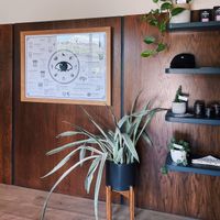 Interior merchandise shelves and menu on the wall. at Elegy Coffee in Nashville