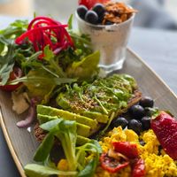 Combo scrambled tofu, avocado toast, salad, chia cup. at Lycka in Meilen