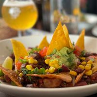 Jackfruit enchilada with tortilla chips, pico de gallo, corn, avocado cream, lime, and coriander.  at La Mujer de Verde in Mallorca